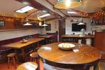 Saloon of the Chateauroux with wooden dining tables and benches