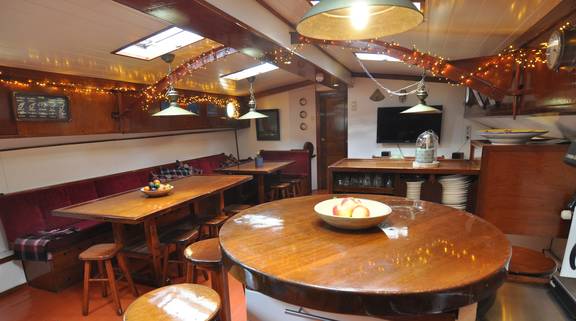 Saloon of the Chateauroux with wooden dining tables and benches