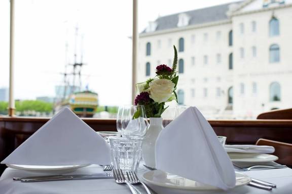 Table set aboard the Dame van Amstel overlooking the National Maritime Museum