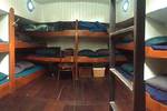 Cabin with wooden bunk beds on the Dankbaarheid
