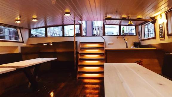 Saloon of De Hester with dining tables and benches