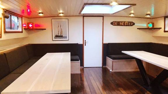 Saloon of De Hester with dining tables and benches