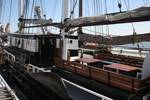 Wooden benches and tables in the deck seating area of the Vrijheid