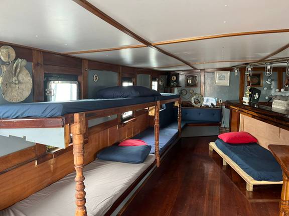 Bunk beds and a separate bed in the former wheelhouse of the Vrijheid