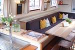 Bench seating and bar in the saloon of De Hester