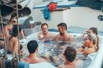 Guests relaxing in the hot tub on the deck of De Hester