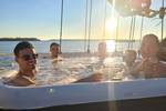 Group in the hot tub of De Hester with the sun low in the sky