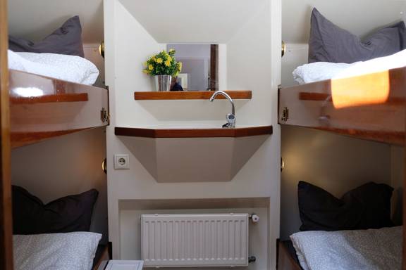 Four-berth cabin with bunk beds and a washbasin on De Hester