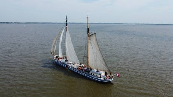 Aerial view of De Hester sailing on open water