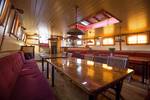 Saloon of the Eenhoorn with wooden tables and red benches