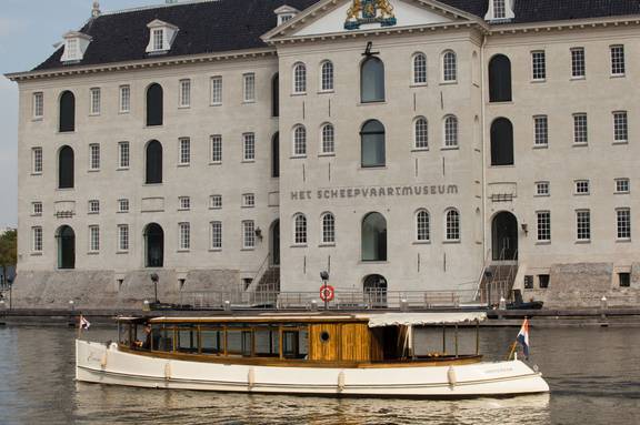 Saloon boat Emma in front of the National Maritime Museum in Amsterdam