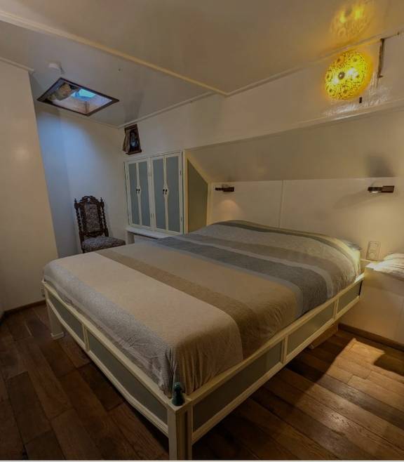 Double bed in a bright cabin of the Engelburg