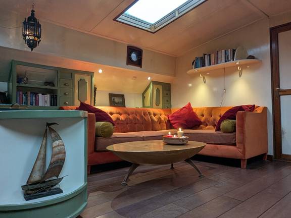 Seating area with a sofa and wooden table in the saloon of the Engelburg