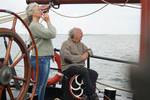 Sailor at the helm of the Engelburg under sail