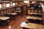Wooden dining tables and chairs in the saloon of the Frisius van Adel