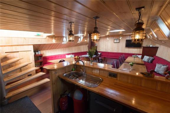 Bar and stairs to the deck in the saloon of the Grietje