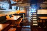 Saloon of the Johanna Engelina with dining tables and stairs to the deck
