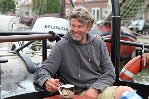 Skipper Hans Luining sitting on the deck of the Korevaer