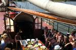 Guests sharing a meal in the deck seating area of the Korevaer