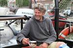 Skipper Hans Luining sitting on the deck of the Korevaer