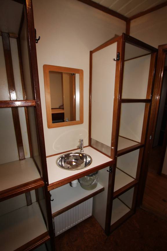 Washbasin and storage shelves in a cabin of the Korevaer