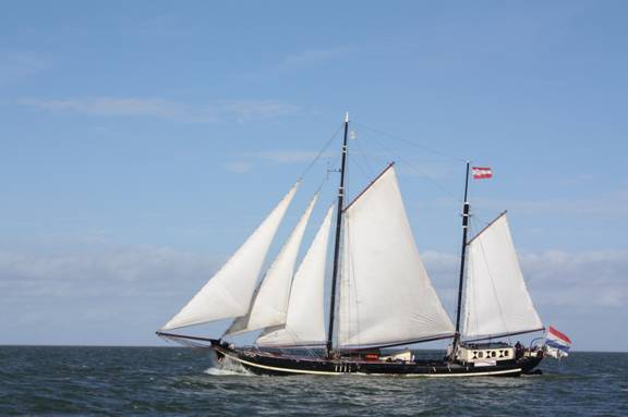 Two-masted clipper Korevaer under white sails on open water