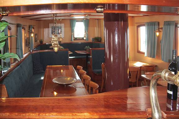 Saloon of the Mars with wooden tables and green benches