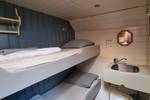 Cabin with a bunk bed and washbasin on the Medusa