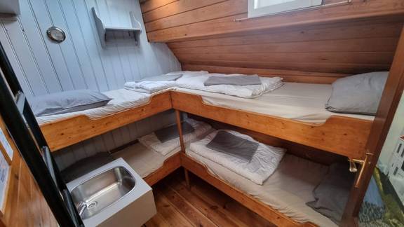 Cabin with wooden bunk beds on the Medusa