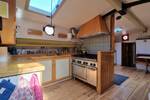 Open galley with a cooker and wooden cabinets on the Medusa