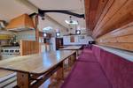Saloon of the Medusa with long wooden tables and red benches