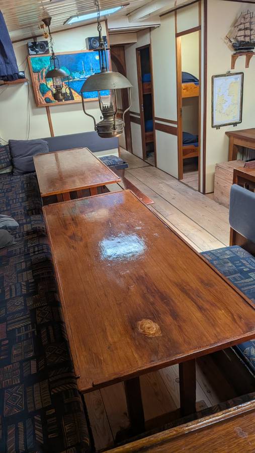 Long wooden dining table in the saloon of the Meridiaan