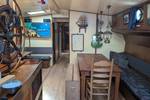 Saloon of the Meridiaan with wooden tables and blue bench seating