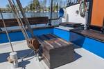 Deck seating area with blue benches on the Meridiaan