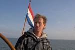 Skipper Egbert Stofbergen at the helm of the Nieuwe Zorg