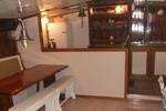 Saloon of the Nieuwe Zorg with wooden tables and white benches
