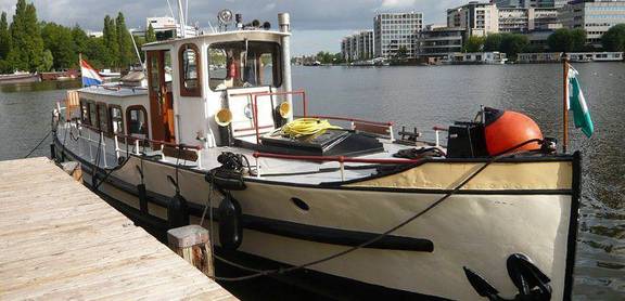Saloon boat Oude Maze moored at the quay