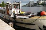 Saloon boat Oude Maze moored at the quay