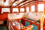 Wooden galley with green cupboard doors on the Pelikaan