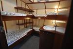 Cabin with bunk beds and a washbasin on the Poseidon