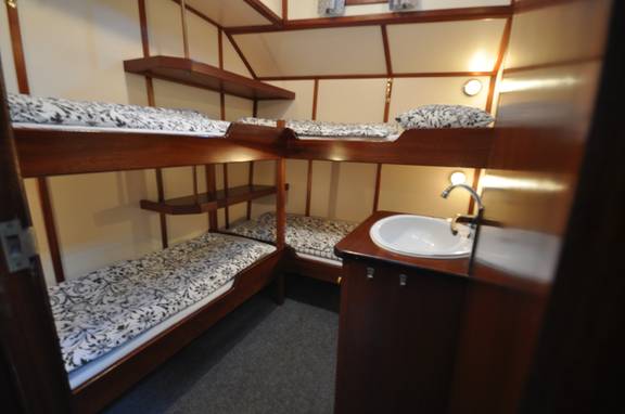 Cabin with bunk beds and a washbasin on the Poseidon