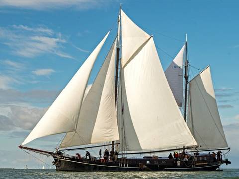 Two-masted clipper Pouwel Jonas with white sails hoisted