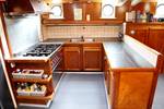 Wooden galley with a cooker and worktop on the Rival
