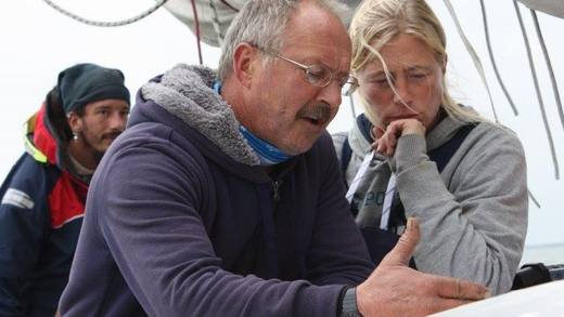 Skipper Arno van Aartrijk explaining something to a guest on deck