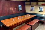 Dining area with a wooden table and benches in the Spartivento