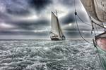 Spartivento sailing on choppy water beneath dark clouds