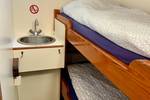 Cabin with a bunk bed and washbasin on the Spartivento