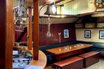 Saloon of the Spartivento with a bar and dining table