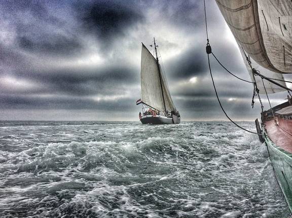 Spartivento sailing on choppy water beneath dark clouds