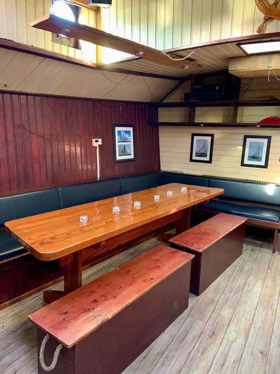 Dining area with a wooden table and benches in the Spartivento